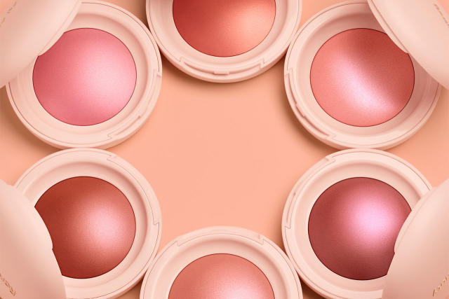 A model with glowing skin, wearing Rare Beauty highlighter, radiating natural luminosity and beauty.