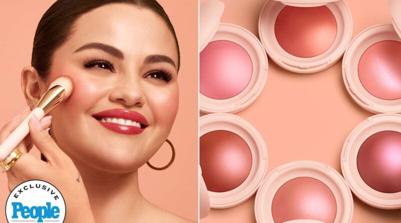 Close-up of a hand holding a compact of Rare Beauty highlighter, showcasing its radiant glow and sleek packaging.