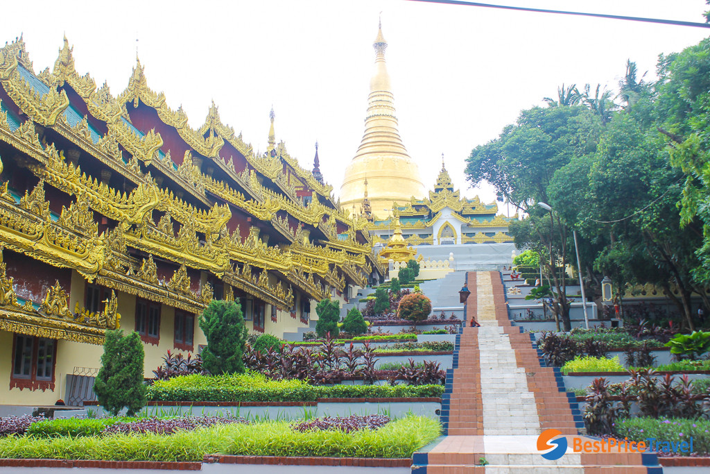 A panoramic view of the Shwedagon Pagoda complex, with smaller stupas and pavilions surrounding the main stupa 