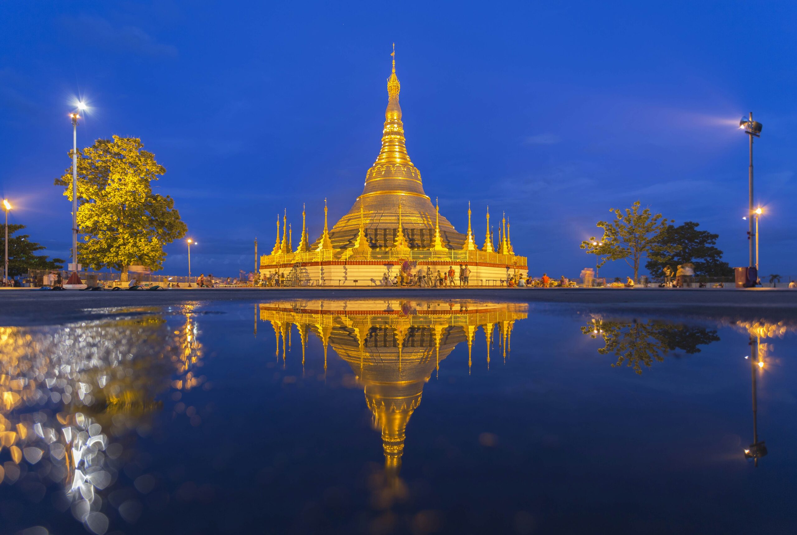 Intricate carvings and statues adorning the base of Shwedagon Pagoda, showcasing Burmese craftsmanship 