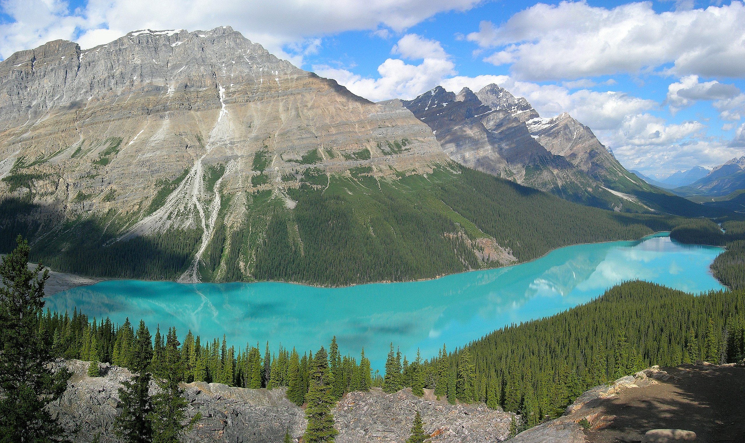 Hikers on a scenic trail surrounded by mountain vistas 